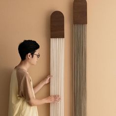 a young man standing next to a tall wall clock