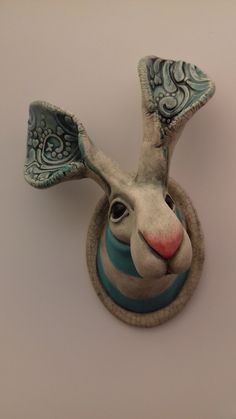 a ceramic animal head mounted on the wall