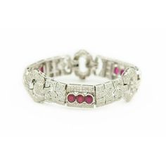 Stunning .84" wide Art Deco style diamond and ruby 18k white gold bracelet featuring three rectangular section that each have 3 bezel set oval rubies surrounded by bead set diamonds and three oval diamond sections..  The approximate total diamond weight is 13.44 carats.  Marked 18k.  Rubies measure approximately 6.22mm x 4.52mm x 3.10mm each. Wide Art, White Gold Bracelet, Bead Set, Art Deco Style, Oval Diamond, Deco Style, Bezel Setting, Art Deco Fashion, Gold Bracelet