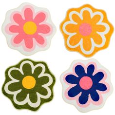 four flower shaped coasters on a white background