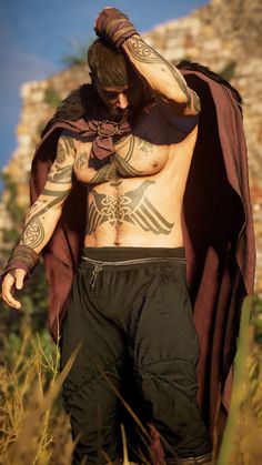 a man with tattoos on his chest and arms standing in tall grass wearing a cape