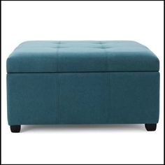 a blue ottoman sitting on top of a white floor