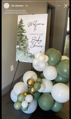 balloons are stacked on top of each other in front of a welcome sign