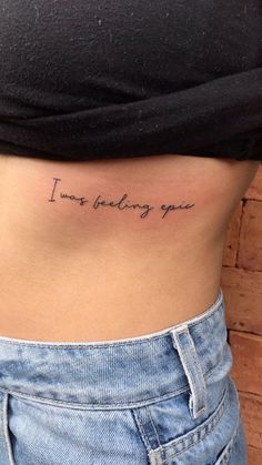 a woman's stomach with the words i love being you tattooed on her side