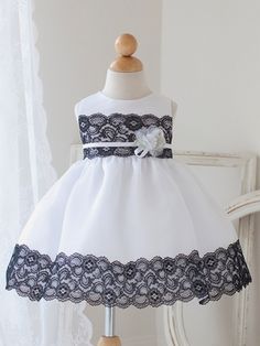 White & Black Dress w/ Lace Detailing & Flower Sleeveless Lace Patchwork Dress For Dress-up, Formal Lace Dress With Lace Patchwork, Lace Dress With Lace Back For Dress-up Occasions, Lace Dress With Lace Trim For Dress-up Occasions, Elegant Sleeveless Lace Dress For Dress-up, White Lace Dress For Dress-up Occasion, White Lace Dress For Dress-up, White Lace Dress With Lace Bodice For Dress-up, White Lace Dress With Lace Trim For Dress-up