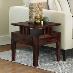 a wooden table sitting on top of a rug next to a couch