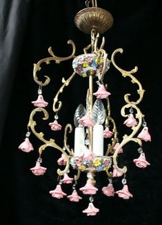 a chandelier with pink and white flowers on it