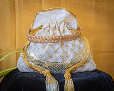 "This listing is for 1 bag.  Product Dimensions (Height X Length) - 8\"x 10\" (Inches) Color - Royal White with Golden Threadwork and Silver Gota Patti Lace, Gold Handle.  Material - Embroidered Silk with Golden Thread work, Beaded Glass Tassels, Gota Patti Lace Suitable As - Perfect for Weddings or Family Functions/Occasions, Festivals, Meet-ups, Outings, Gifts for Her. The scope is a friend of your imagination.   * * Contact Us * *  If you can't find the answer to your question, please feel fr Rectangular Shoulder Bag With Dust Bag For Wedding, Traditional Gold Shoulder Bag With Embroidery, Traditional Gold Rectangular Pouch, Ceremonial Gold Embroidered Bag, Gold Embroidered Ceremonial Bag, Traditional Gold Shoulder Bag With Gold Embroidery, Gold Embroidered Bags For Ceremonial Occasions, Gold Embroidered Wedding Clutch Bag, Festive Rectangular Bag With Gold Embroidery