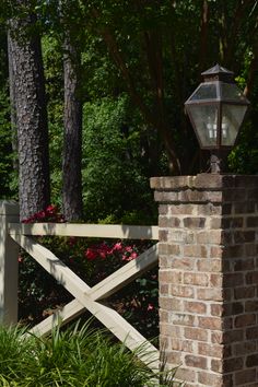 a brick gate with a lantern on top