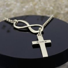 Infinity Cross Name Necklace Sterling Silver - infinity symbol and cross. This necklace is worn asymmetrical so the cross hangs lower. lovely and classy! Engraved with a name on the cross to be personal! Item specifics: Thickness 1.2mm/0.047" Hook Single Hook Material Sterling Silver Chain type Cable Chain Infinity Size 2 x 0.7cm/ 0.79" x 0.28" Material Sterling Silver 925 Font: DELIVERY & SHIPPING Delivery Time= Processing Time + Shipping Time For every piece in our collection, the estimate Silver Cross Jewelry With Name, Minimalist Personalized Cross Pendant Necklace, Personalized Elegant Cross Necklace, Elegant Personalized Cross Necklace, Silver Cross Necklaces With Name Detail, Silver Name Necklace With Cross Shape, Personalized Silver Cross Pendant Necklace, Personalized Elegant Crucifix Cross Necklace, Personalized Cross Necklace For Anniversary