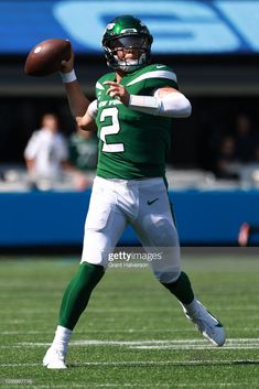 a football player throwing a ball on the field