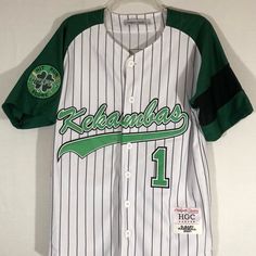 Introducing The Headgear Classic Men's Jersey G-Baby Hardball 2001! This Stylish And Comfortable Jersey Is Perfect For Both Casual Wear And Sports Activities. Featuring A Classic Striped Pattern In White And Green, Short Sleeves, And A Button Closure, It Is Made Of 100% Polyester Material That Is Machine Washable For Easy Care. The Size Of This Jersey Is S And It Is Suitable For Men's Regular Fit. It Is Also Great For Cycling As It Has Performance Activity Features. This Item Is New With Tags An Cotton Jersey For Streetwear With Team Spirit, Cotton Jersey For Streetwear During Sports Season, White Casual Jersey With Graphic Print, Casual White Jersey With Graphic Print, Green Casual Jersey For Sports Events, Casual Green Jersey For Sports Events, Green Team Name Tops For Streetwear, Cotton Jersey For Sports Season Streetwear, Casual Baseball Jersey For Fans