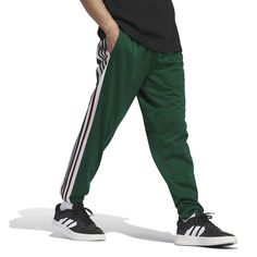 Break away from boring in these adidas track pants. With ribbed cuffs and a comfy tricot build, they move with you whether you're wandering city streets or lounging at home. Click on this MEN'S GUIDE to find the perfect fit and more!Break away from boring in these adidas track pants. With ribbed cuffs and a comfy tricot build, they move with you whether you're wandering city streets or lounging at home. Click on this MEN'S GUIDE to find the perfect fit and more!TECHNOLOGIES & FEATURES Side panel Adidas Track Pants, Adidas Track, World Of Sports, Bottom Clothes, City Streets, Sporty Style, Panel Siding, Bottoms Pants, Adidas Men