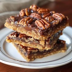 three pieces of pecan bar stacked on top of each other