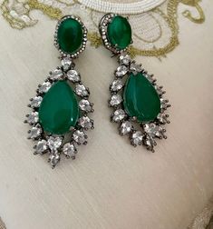 Emerald Green Diamond Earrings will be your perfect mate for the evening! Sparkle in this luxurious pair of Victorian earrings which are sure to make heads turn.  Details: Earrings Length-3 Inches Weight of Each Earring-23 grams All products are manufactured using traditional skills from our rich heritage of crafts.  The process of these crafts is essentially manual. Hence, any irregularities or variations are an inherent part of these handcrafting processes. Victorian Dangle Chandelier Earrings For Parties, Victorian Chandelier Dangle Earrings For Party, Victorian Style Party Chandelier Earrings, Victorian Dangle Earrings For Party, Victorian Green Earrings For Wedding, Elegant Clip-on Teardrop Party Earrings, Victorian Style Drop Earrings For Party, Elegant Clip-on Teardrop Earrings For Party, Elegant Green Jeweled Bridal Earrings