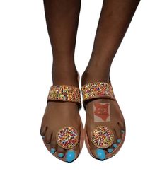 Beautifully designed African beaded sandals, Masai sandals, summer sandals, African sandals Made from fine leather and very fine beads. Available in all sizes. Kindly, using the chart provided in the pictures above, check your foot size in EUR and US sizes before placing your order. Wholesale is available upon request at a discount price. Shipping is via DHL EXPRESS with a GUARANTEED delivery between 3-5 days worldwide. **BUY MULTIPLE ITEMS, PAY SHIPPING ONCE** FREE SHIPPING FOR ALL ADDITIONAL I Beach Festivals Toe Post Sandals, Beach Festival Toe Post Sandals, Toe Post Sandals For Beach Festivals, Round Toe Sandals For Party Festivals, Festival Round Toe Sandals For Parties, Festival Party Sandals With Round Toe, Open Toe Barefoot Sandals For Festivals And Vacation, Beaded Flat Heel Sandals For Beach, Multicolor Round Toe Sandals For Festivals