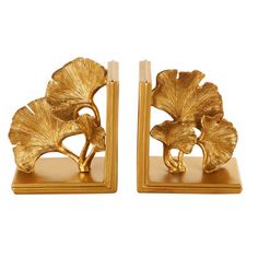 a pair of gold bookends with flowers on them