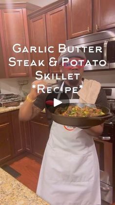 a woman in an apron holding a skillet with food on it and the words garlic butter steak and potato skillet recipe