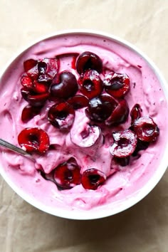 a bowl filled with ice cream and cherries