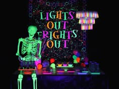 a skeleton sitting on top of a table in front of a sign that says lights out rights out