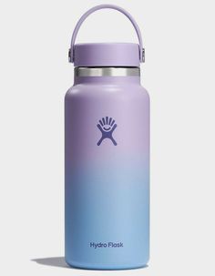 the hydro flask water bottle in purple and blue is shown with a handle on it