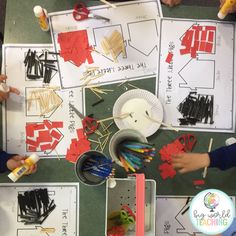 children are doing crafts with paper plates and scissors on the table, surrounded by other materials