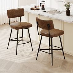 two brown barstools sitting on top of a kitchen counter next to a window