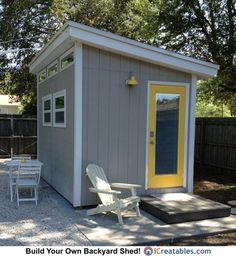 a small backyard shed with a yellow door and white lawn chairs in the back yard