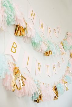 a birthday banner with gold and pink decorations