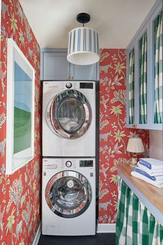 an image of a washer and dryer in a room with red wallpaper