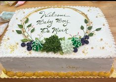 a cake with white frosting and green decorations