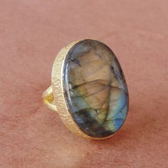 Made In India, Make the season's greeting a memorable one with this 18k gold plated brass single oval gemstone ring. Handmade with high quality labradorite, this simple everyday ring will make Christmas a day to remember.Natural Labradorite Ring, Yellow Gold Plated Ring, Polished Gemstone Ring, Statement Ring, Bezel Set Ring, Oval Shape Ring, Gift For WomenProduct DetailsItem Code: IAJBR-0135Gross Wt. 7.30 GmsStone Name: LabradoriteStone Shape : OvalStone Dimension : 16*22mmMetal: 18K Yellow Gol Oval Shape Ring, Black Tourmaline Ring, Bezel Set Ring, Ring Bezel, Everyday Ring, Everyday Rings, Set Ring, Labradorite Ring, Ring Oval