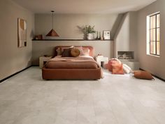 a large bed sitting in the middle of a living room next to a wall mounted shelf