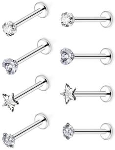 six pairs of surgical piercings with clear crystal stones on each bar and one star