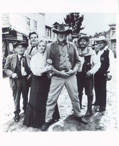 an old black and white photo of people standing together