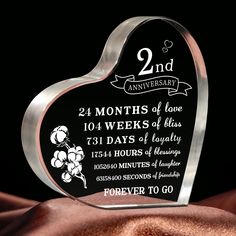 a heart shaped glass plaque with an anniversary date