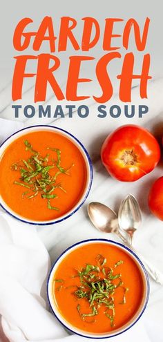 two bowls of tomato soup on a marble surface with tomatoes and herbs in the background