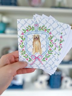 a person holding up some cards with a dog on them