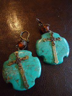 Southwestern Inspired One of a kind handcrafted earrings. Beautiful vintage colored filigree bead cap with tangerine colored bead in detail.  Turquoise with mission cross details 1 1/2 inches wide and 1 1/2 inches across. Weighs 7 oz per earrings, length 2 3/4 inches including ear wires. These simply draws the eyes in. New, Never worn, One of a kind. Bohemian Turquoise Cross Jewelry, Bohemian Turquoise Hand-tooled Earrings, Bohemian Hand Tooled Green Jewelry, Handmade Bohemian Cross Jewelry, Collectible Bohemian Earrings, Bohemian Collectible Earrings, Handmade Turquoise Cross Jewelry, Blue Bohemian Hand-tooled Earrings, Vintage Hand Tooled Turquoise Jewelry