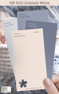 someone holding up some paint samples in their hand with the words sw 632 intimate white on them