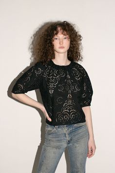 Structured blouse with voluminous short sleeves in an intricate openwork cotton lace. Elegant pleat detail at neck. Semi sheer. Unlined. Made in New York City. Fabric is 100% cotton. Avery is 5'10", bust 31", waist 24", hip 35", and is wearing a size S. Fitted Short Sleeve Top With Broderie Anglaise, Short Sleeve Blouse With Broderie Anglaise For Daywear, Fitted Broderie Anglaise Short Sleeve Top, Short Sleeve Broderie Anglaise Blouse For Daywear, Chic Short Sleeve Tops With Broderie Anglaise, Chic Short Sleeve Eyelet Blouse, Elegant Broderie Anglaise Lace Top With Short Sleeves, Elegant Short Sleeve Lace Top With Broderie Anglaise, Summer Lace Top With Broderie Anglaise Short Sleeves