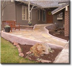 a stone walkway in front of a house