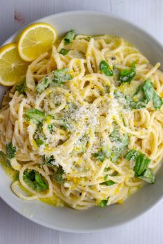 a white bowl filled with pasta and broccoli