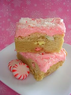 two pieces of cake sitting on top of a white plate next to a candy cane