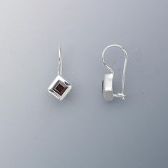 Brilliant faceted garnet, rich with natural color. Rim set with open back for a secure fit and stunning radiance. Cast sterling silver packaged with anti-tarnish paper to maintain long-lasting shine. Faceted Sterling Silver Earrings Fine Jewelry, Modern Silver Earrings With Birthstone, Modern Silver Birthstone Earrings, Silver Faceted Fine Jewelry Earrings, Faceted Silver Fine Jewelry Earrings, Fine Jewelry Silver Faceted Earrings, Faceted Sterling Silver Earrings For Formal Occasions, Classic Silver Garnet Earrings, Silver Garnet Earrings For Formal Occasions