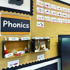 a bulletin board with phonics written on it and pictures hanging from the wall