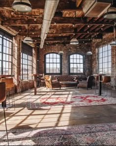 an industrial loft with exposed brick walls and large windows