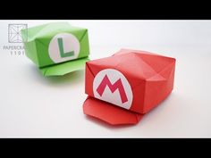 two origami blocks with the letter l on them, one red and one green