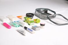 an assortment of cosmetics and eyeglasses on a table