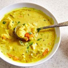 a white bowl filled with soup on top of a table